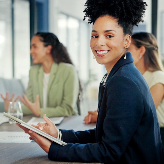 Business woman looking at camera in meeting Propel Purpose Services