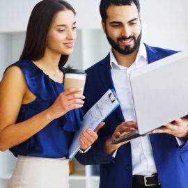 Propel Enterprises_ Fourfold Cornerstone_Image_270 x 270_Latino business man and woman standing and looking at laptop