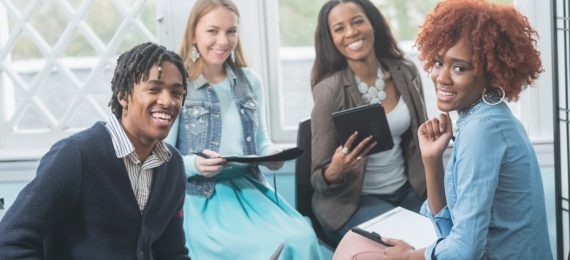 Propel Enterprises_ Fourfold Cornerstone_Image_570 x 263_Diverse group of business people smiling in meeting